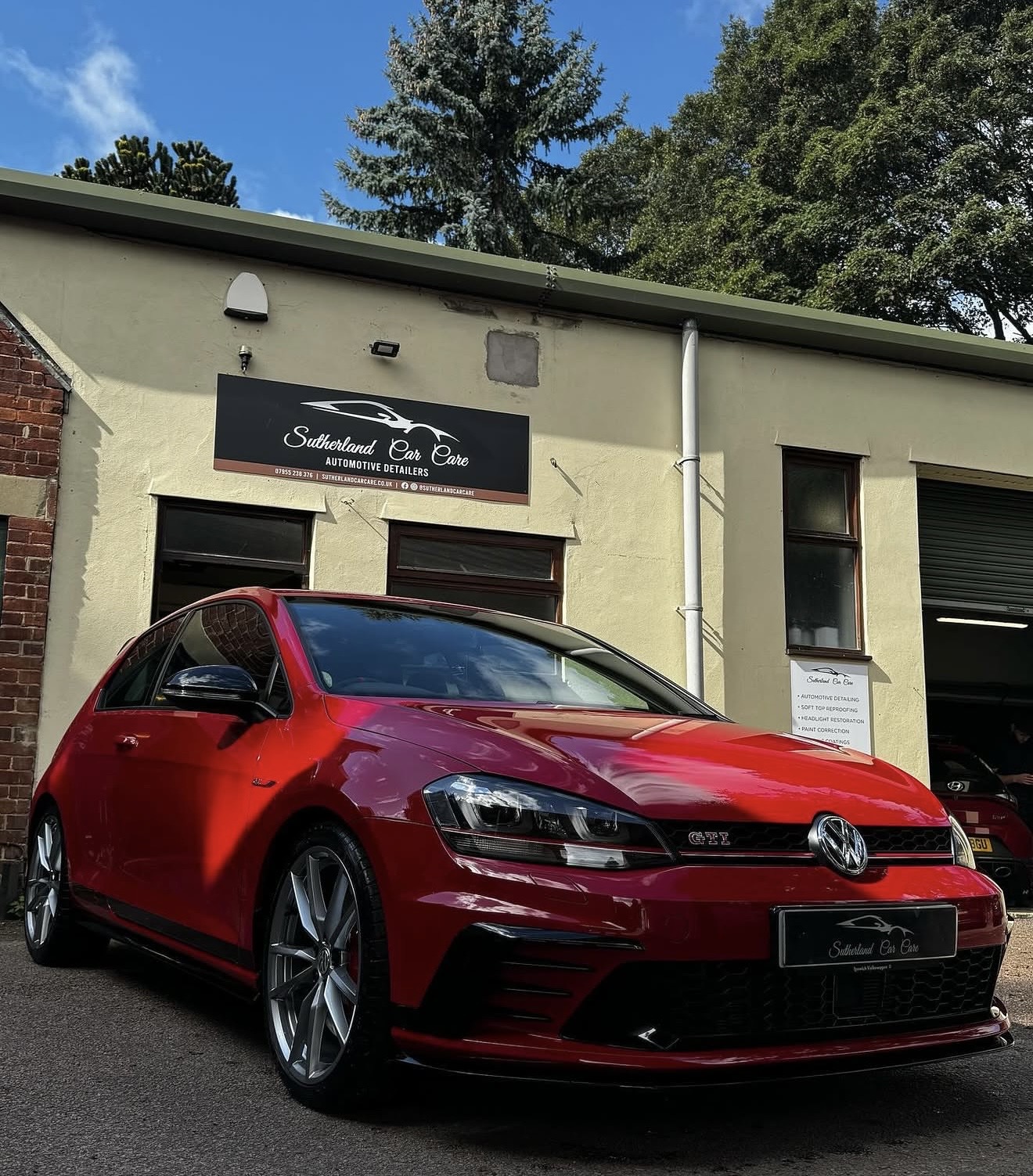 Red Volkswagen Golf GTI outside the Sutherland Car Care studio